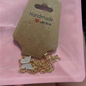 Golden necklace with metallic white butterfly